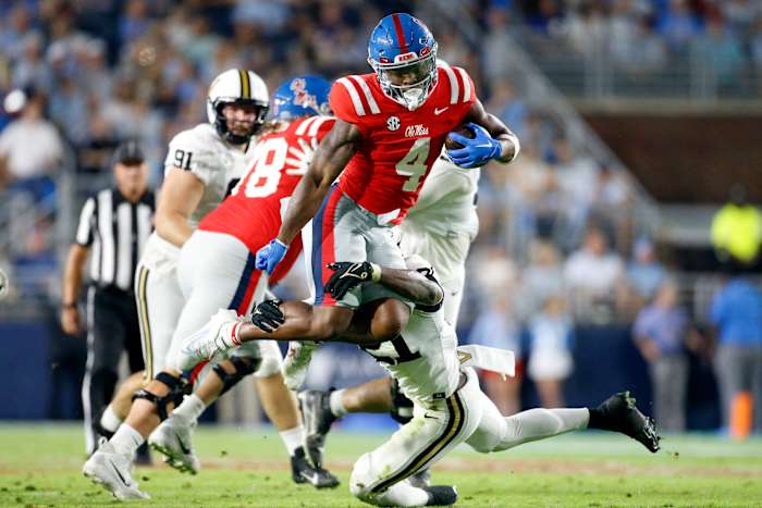 Oct 28, 2023; Oxford, Mississippi, USA; Mississippi Rebels running back Quinshon Judkins (4) leaps over Vanderbilt Commodores defensive back Savion Riley (21) as he makes the tackle during the first half at Vaught-Hemingway Stadium. Mandatory Credit: Petre Thomas-USA TODAY Sports